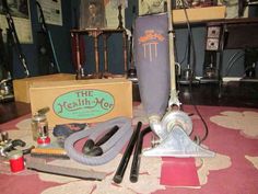 an assortment of tools are sitting on the floor in front of some books and other items