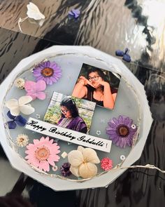 a birthday cake decorated with flowers and photos