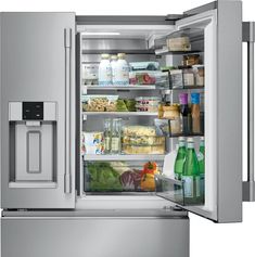 an open refrigerator with its door wide open and full of fresh food, including vegetables