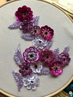 a close up of a embroidery with flowers on it