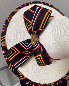 ombines timeless elegance with vibrant cultural flair. Handcrafted with care, this hat features a beautifully woven straw base adorned with bold African print fabric, offering both style and sun protection. Perfect for church services, outdoor events, or simply adding a touch of sophistication to your outfit, this hat blends tradition with modern design. Lightweight and breathable, it's as comfortable as it is striking. Elevate your look with a hat that celebrates heritage and craftsmanship. One size: should fit all. Bohemian Multicolor Straw Hat For Kentucky Derby, Multicolor Bohemian Straw Hat For Kentucky Derby, Multicolor Hat Bands For Beach In Spring, Multicolor Hats For Kentucky Derby And Beach, Multicolor Hat For Beach And Kentucky Derby, Elegant White Woven Sun Hat, Summer Fedora Sun Hat For Church, Traditional Fedora Panama Hat For Summer, Multicolor Flat Brim Sun Hat For Kentucky Derby