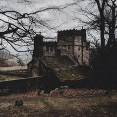 an old stone building with trees in the background