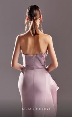 the back of a woman's dress, with her hands on her hips