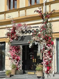 an entrance to a building decorated with flowers