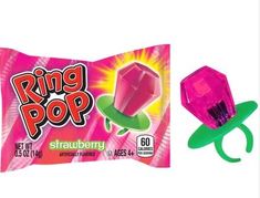 a pink ring pop sitting next to a candy bar