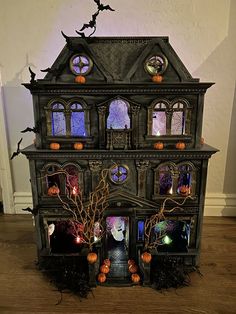 a halloween house with pumpkins and bats on it