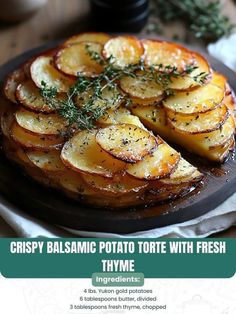 crispy balsamic potato torte with fresh thyme on a black plate