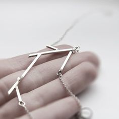 "Handmade sterling silver necklace from the \"Sticks\" collection. The geometrized twig follows the shape of the necklace. On each end of the twig the necklace continues with a delicate but strong chain and a hook and eye clasp. Length: 61cm (24\") Centrepiece: 7x2.5cm * Necklace comes with a hook and eye clasp. If you would like a spring ring/lobster clasp instead, just leave a note. Visit my shop: http://www.etsy.com/shop/jewelryMirta © MIRTA" Modern Long Sterling Silver Necklaces, Modern Long Sterling Silver Chain Necklace, Modern Sterling Silver Long Chain Necklace, Minimalist Silver Pendant Chain Necklace, Modern Handmade Sterling Silver Necklace, Modern Sterling Silver Long Necklace, Modern Sterling Silver Necklace With Silver Chain, Modern Sterling Silver Necklace For Everyday, Minimalist Silver Necklace With Delicate Chain