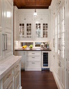 a white kitchen with lots of cabinets and counter top space in the center is featured on instagram