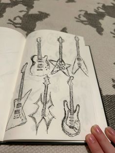 an open book with guitars drawn on it