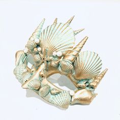 Embrace the magic of the ocean with masks inspired by the legendary King Triton and Queen Athena. One mask shines in mesmerizing copper, while the other glistens in enchanting turquoise and gold, creating a perfect complement. These masks are adorned with intricate seashell designs, ensuring you both stand out as the true rulers of the sea.


Age Group/Gender - Adult/Unisex

Size/Type - One size fits all adults

Mask Color - Copper, turquoise/gold

Mask Material - Polyresin

Accent Material - Pa