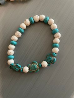 Get your beach vibe stretch bracelet with three blue turquoise turtles linked together by small round natural blue and white turquoise beads. Approx. 7.75-8" (will take requests for different size) Beaded Turtle, Turtle Bracelet, White Turquoise, Jacksonville Fl, Beach Vibe, Blue Turquoise, Turquoise Beads, Stretch Bracelet, Turquoise Blue