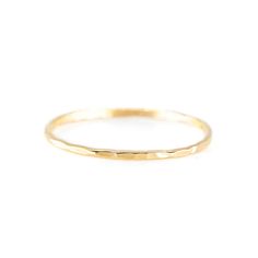 This dainty stacking ring is hammered by hand and is made from 14/20 gold filled wire. It's perfect for stacking with our other rings or worn alone for a minimalist look. 1.1mm Band 14/20 gold filled Hypoallergenic Everyday Hammered Gold Rings, Dainty Hammered Yellow Gold Rings, Classic Hammered 14k Gold Stackable Rings, Minimalist Hammered Gold Stackable Rings, Classic 14k Gold Stackable Hammered Rings, Delicate Stacking Rings, Rough Gemstone Ring, Slim Ring, Dainty Gold Jewelry