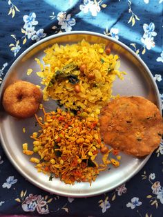 an assortment of food on a plate with blue and white table cloth, including fried rice