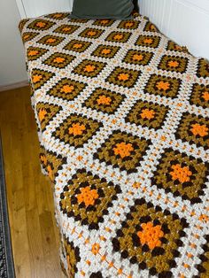 a crocheted blanket on top of a bed