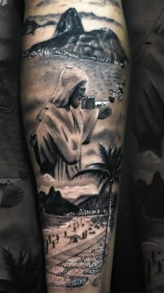 a man's leg with a black and white tattoo on it, depicting the image of jesus