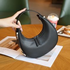 Discover Elegance and Versatility Step into a world of style and sophistication with our Elegant Leather Moon-Shaped Shoulder Bag, designed exclusively for the chic, modern woman. Crafted from high-quality split leather with a sleek polyester lining, this bag showcases a unique half-moon silhouette that is both eye-catching and functional. Whether you're heading to a casual brunch or an elegant evening event, this versatile accessory is your perfect companion. Product Features Type: Shoulder & H Chic Handheld Business Bags, Modern Evening Bag With Large Capacity, Elegant Large Capacity Clutch Baguette Bag, Elegant Faux Leather Shoulder Bag For Travel, Elegant Faux Leather Travel Shoulder Bag, Elegant Large Capacity Baguette Clutch Bag, Large Capacity Handheld Baguette Bag For Evening, Modern Large Capacity Evening Bag, Trendy Formal Handheld Hobo Bag