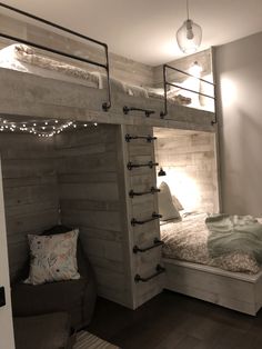 a bunk bed with lights on the top and bottom is made out of wood planks