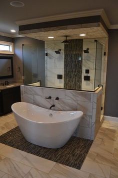 a large white bath tub sitting inside of a bathroom