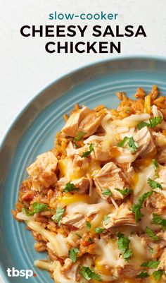 a blue plate topped with chicken and cheese