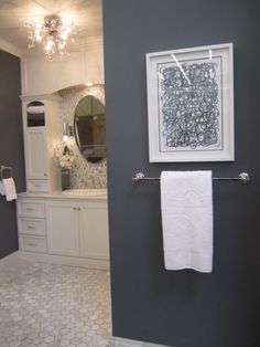 a bathroom with gray walls and white fixtures