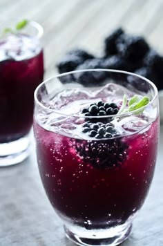 two glasses filled with blueberries and ice