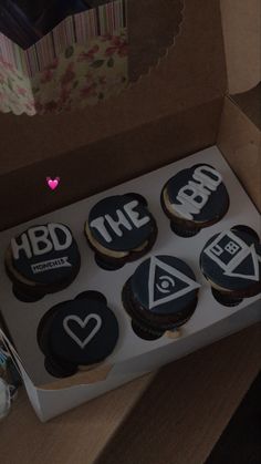 a box filled with decorated cookies sitting on top of a table