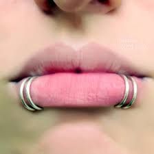 a woman's lips with rings on her lip