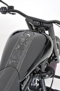 the front end of a black motorcycle on a white background