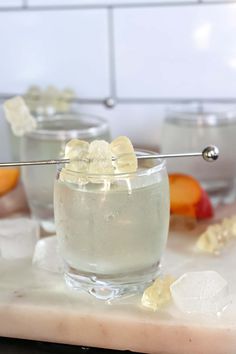 a glass filled with ice sitting on top of a counter