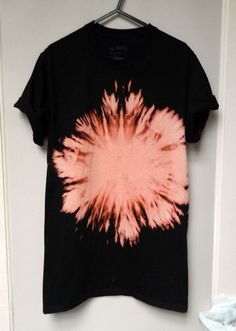 a black and pink tie dye shirt hanging on a door