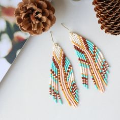 These perfectly joyful and beautiful unique earrings are the perfect way to show off your love of the harvest season. An unexpected combination of pearl, maize, peach, brown and turquoise this pair is reminiscent of flint corn and brings all the fall vibes. Beautiful on any skin tone or hair color. Details: Handcrafted by artisans in Medellin, ColombiaMaterials: Seed beads, stainless steel hardware for comfort and longevitySize: Approximately 3.5 inches from top of hook, 1 inch wideSKU: E1144 FO Handmade Brown Beaded Summer Earrings, Handmade Brown Beaded Earrings For Summer, Handmade Peach Dangle Jewelry, Multicolor Earthy Dangle Earrings, Earthy Multicolor Earrings For Gift, Earthy Multicolor Dangle Earrings, Earthy Multicolor Earrings Perfect For Gifts, Artisan Brown Earrings With Colorful Beads, Brown Earrings With Colorful Beads For Gift