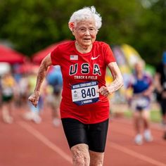 an older woman running in a race