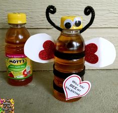 a honey jar with a bee on it next to two bottles filled with honey and a sticker that says mott?