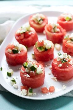 tomatoes with feta cheese and herbs on a white plate