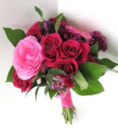 a bouquet of red and pink flowers on a white background