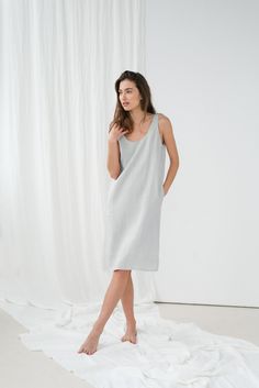 "Loose UMA sleeveless dress in ice grey. - length is ± 105 cm (41.3\") (depends on size) - with pockets - straight cut - loose fit NOTE: This dress is oversized, please have this in mind when choosing your size. DETAILS: - 100 % European, pre-washed medium weight linen (205 g/m²) - the model is 180 cm (5′11″) high, wearing size S. - model measurements: bust 84 cm (33\") / waist 61 cm (24\") / hips 92 cm (36\") - color in the picture - ice grey (you can choose other color on the right) MADE TO OR Sleeveless Relaxed Fit Midi Dress For Loungewear, Sleeveless Midi Dress With Relaxed Fit For Loungewear, Relaxed Fit Sleeveless Midi Dress For Loungewear, Gray Midi-length Summer Dresses, Gray Knee-length Midi Dress For Summer, Gray Knee-length Summer Midi Dress, Sleeveless Loungewear Dress With Pockets, Sleeveless Lounge Dress With Pockets, Gray Sleeveless Sundress