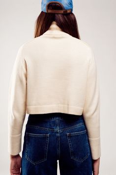 Evoking memories of the 90s, this high neck cropped cream jumper provides an oversized fit that makes you look tomboy-inspired yet feminine. Its boxy above-the-waist cut gives you an extra layer on chilly days. It boasts of a turtleneck neckline, long sleeves, ribbed trims, and super soft fabric that is made from 50% Viscose, 28% Polyester, and 22% Polyamide. In our photos, we style it with our Button Front Jean in Mid Blue. The model is 5’9” with measurements of 34-24-36 and is wearing a size s Tan Scarf, Cream Jumper, Scarf Hat, Large White, Hat Hairstyles, S Models, Chunky Knit, High Neck, Jumper