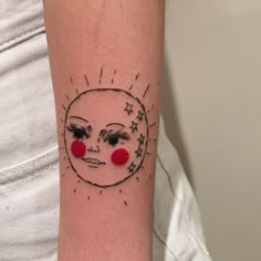 a woman's arm with a sun and moon tattoo on it