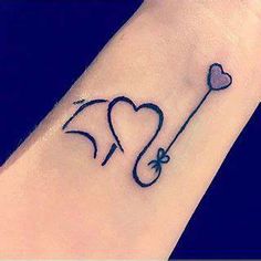 an elephant with a heart and a key tattoo on the wrist