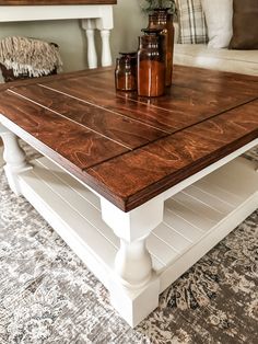 a coffee table with some jars on top