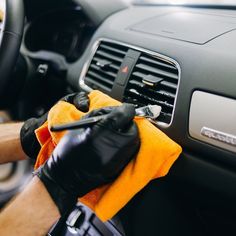 a person cleaning the dashboard of a car