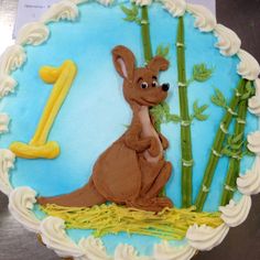 a cake that is decorated to look like a kangaroo and bamboos with the number one on it