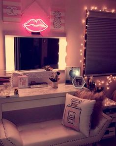 a white desk with a mirror and some lights on it in front of a window