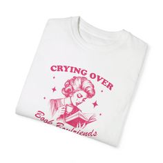 a white t - shirt with an image of a woman reading a book on it