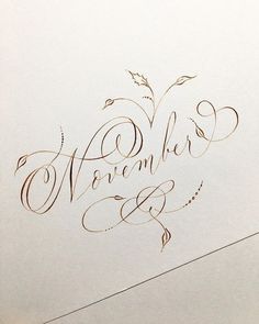 an artistic calligraphy design with the word november written in cursive writing on white paper