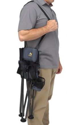 a man with a back pack on his shoulder is looking down at the camera while he holds