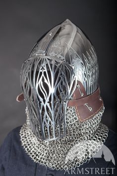 a person wearing a metal helmet with chains on it