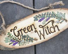 a wooden sign that says green witch on it