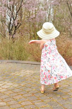 A floral maxi dress that will have your little miss feeling like a summer princess! Maxi dresses are so comfortable and this boho floral is gorgeous. This maxi dress features a racer-back tank. All seams are serged and the neckband and bottom hems are top-stitched for a professional finish and durability. Our fabrics are always pre-washed in free and clear detergent. Made in a smoke-free home. Care: Please wash on gentle cycle in warm water. Do not wash with other clothing or Velcro items! Dry f Cute Summer Beach Maxi Dress, Cute Summer Maxi Dress For Garden Party, Summer Beach Floral Cotton Dress, Cute Pink Floral Dress For Beach, Cotton Floral Sundress For Beach, Playful Flowy Summer Dresses, Cute Flowy Floral Dress For Summer, Cute Flowy Floral Summer Dress, Beach Floral Cotton Dress